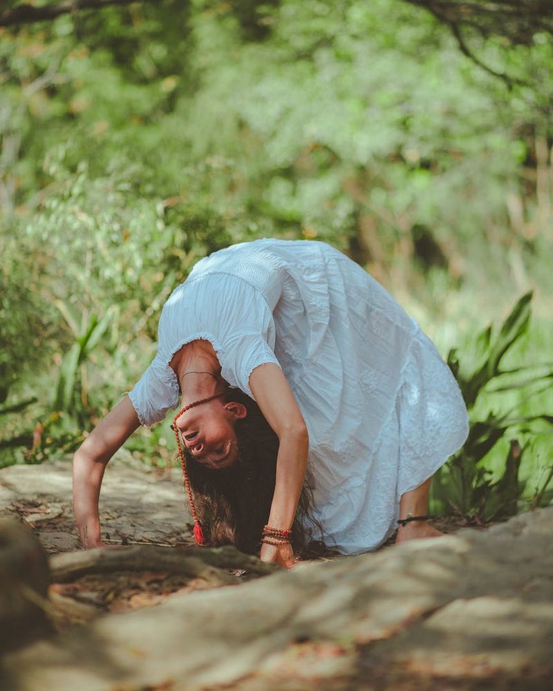 Woman meditating peacefully in a calm, green-toned environment.